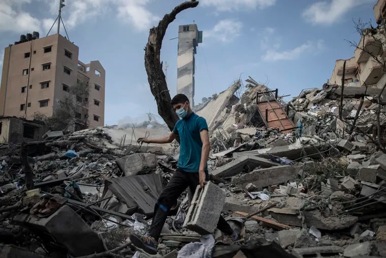 A Palestinian man inspects the damage of a six-story building which was destroyed by an early morning Israeli airstrike in Gaza City on Tuesday.