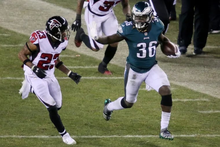 Eagles running back Jay Ajayi fends off Falcons cornerback Robert Alford during the second half of the Eagles’ win on Saturday,