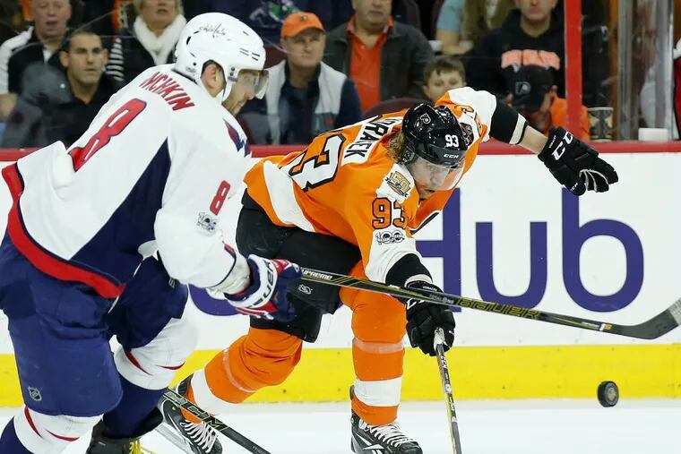 Washington’s Alex Ovechkin (left) and the Flyers’ Jake Voracek battle for the puck in a game last season.
