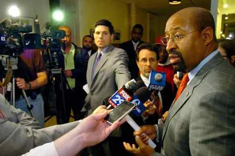 Mike Dunn, left of Mayor Michael Nutter, at a press conference in 2009. (FILE)