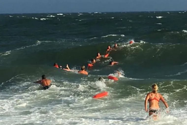 Cape May lifeguards and firefighters form a human chain during Friday's water rescue.