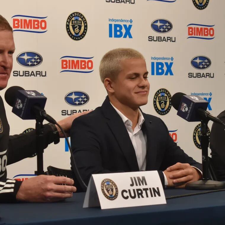 Union manager Jim Curtin (left) pats new 14-year-old player Cavan Sullivan (right) on the back during a news conference at Subaru Park on Thursday.