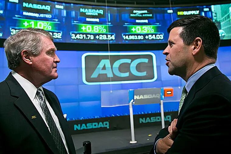 Atlantic Coast Conference commissioner John Swofford, left, and NASDAQ head of listings Bob McCooey chat before the ringing of the closing bell. (Bebeto Matthews/AP)