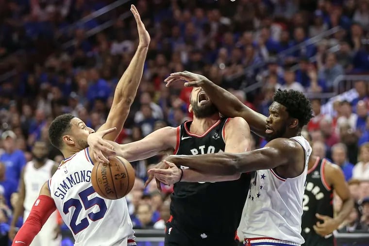 Ben Simmons (left) and Joel Embiid shut down Raptor Marc Gasol in a playoff game last season.