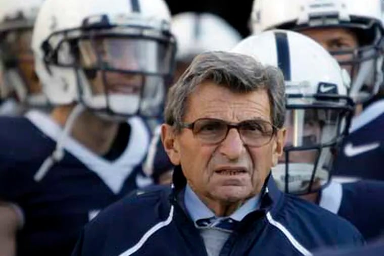 In this Nov. 7, 2009, file photo, Penn State Coach Joe Paterno stands with his players before taking the field for an NCAA college football game against Ohio State in State College, Pa. Paterno and other senior Penn State officials "concealed critical facts" about Jerry Sandusky's child abuse because they were worried about bad publicity, according to an internal investigation into the scandal released Thursday, July 12, 2012. (AP Photo/Carolyn Kaster, File)