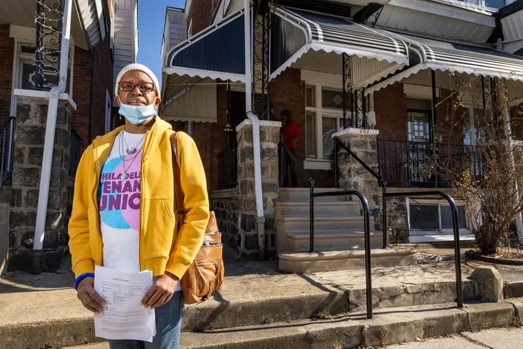 Asantewaa Nkrumah-Ture of S. 55th Street in West Philadelphia in front of her rented row house (right). She is facing a possibly illegal eviction by a new owner.