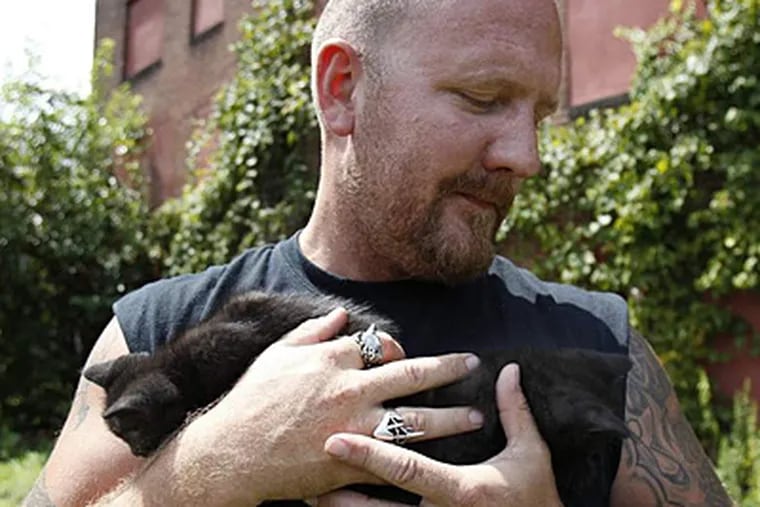 Wolf holds two kittens he helped rescue from an abandoned building Sunday. He said he didn't want the location revealed. (David Maialetti/Staff)