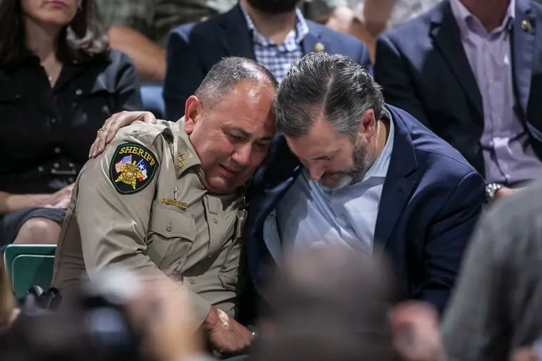 Uvalde County Sheriff Ruben Nolasco (left) is comforted by Sen. Ted Cruz during a vigil held in honor of the lives lost at Robb Elementary School the day before at the Uvalde County Fairplex Arena in Uvalde, Texas, on May 25, 2022.