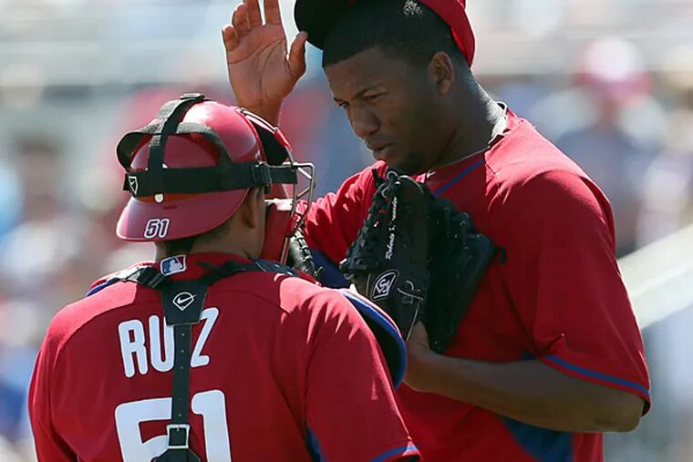 Phillies pitcher Roberto Hernandez talks to catcher Carlos Ruiz in the fourth inning against the Blue Jays on Wednesday. (Yong Kim/Staff Photographer)
