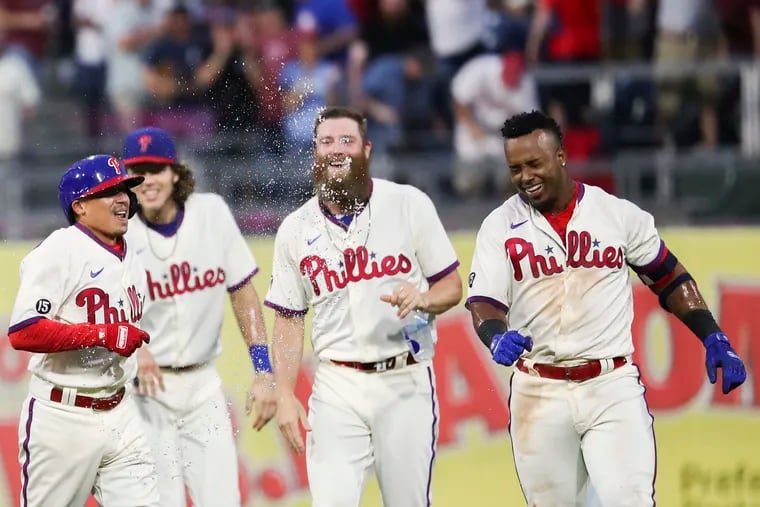 The Phillies' Jean Segura gets a water bottle bath during a celebration of his hit in the bottom of the 10th inning to defeat the New York Yankees.