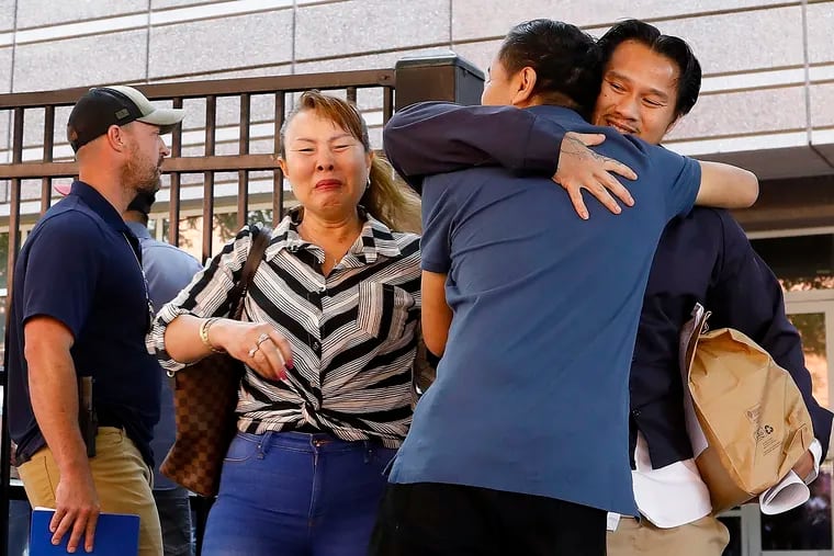 In this Wednesday, June 12, 2019 photo, Ammala Mingsouan embraces family outside the building that houses Immigration and Customs Enforcement and the Atlanta Immigration Court after being released from ICE custody, in Atlanta. Mingsouan's mother Littun Saenbouttaiath, right, said she had not seen him for 24 years.