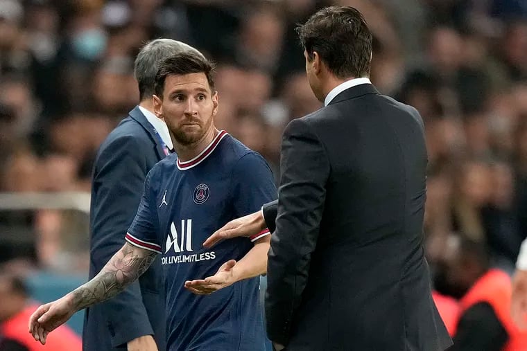 PSG's Lionel Messi looks at head coach Mauricio Pochettino after he was substituted during a league match against Lyon earlier this month.