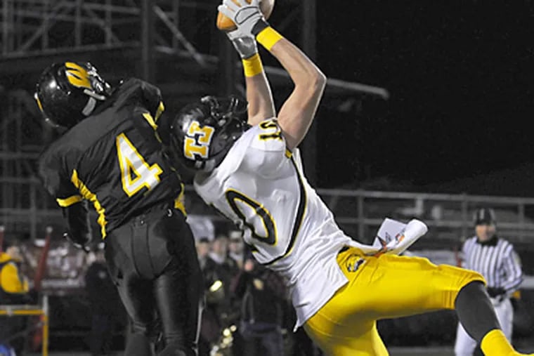 Thomas Jefferson's Evan Zampatti (40) snags a touchdown pass as Archbishop Wood's Scott Atkins (4) defends during Friday night's PIAA Class AAA football championship game in Hershey. (AP Photo/Ralph Wilson)