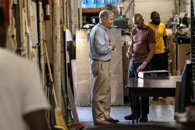 George Limbach, Company Founder, center, interacts with workers during a morning shift at PAR-Recycle Works in Philadelphia Pa. Wednesday, June 26, 2019.ex-offenders take apart old electronic equipment, a pit stop to better jobs after a year in transition at PAR-Recycle.