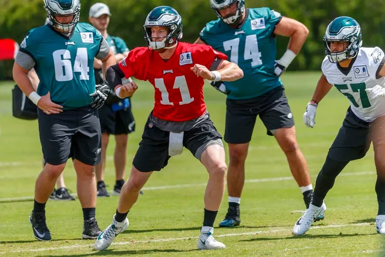 Eagle quarterback Carson Wentz participates in warmups prior to practice on the first day of OTAs at the NovaCare Center on May 21, 2019.