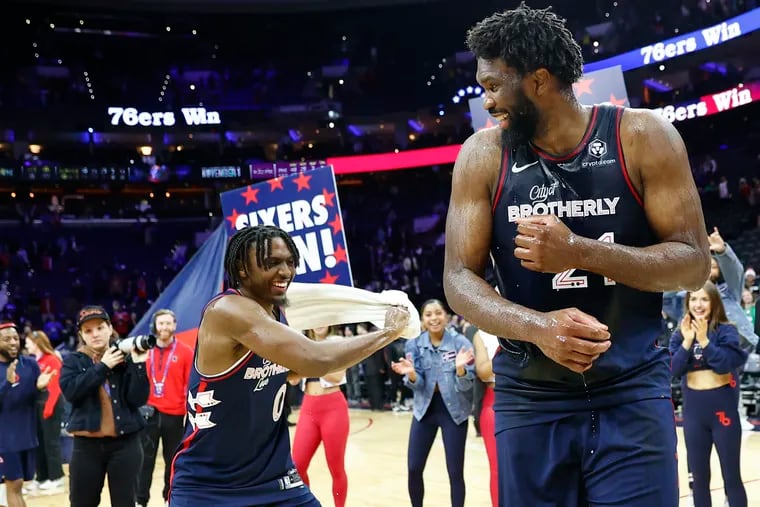 Joel Embiid celebrates with teammate Tyrese Maxey after Embiid scored 70 points against the Spurs.