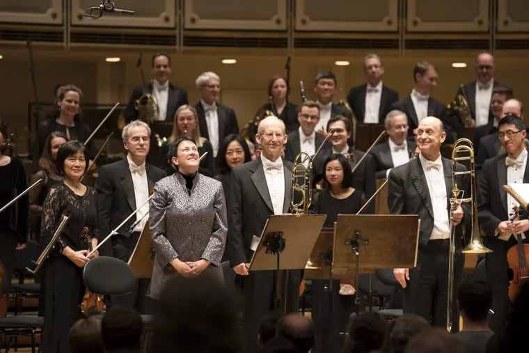 Philadelphia composer Jennifer Higdon (in silver tunic) with the Chicago Symphony Orchestra at the world premiere on Feb. 1 of her ‘Low Brass Concerto.’ The Philadelphia Orchestra performs it Feb. 22-24.