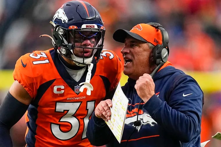 Denver Broncos head coach Vic Fangio talks with free safety Justin Simmons (31) during the fourth quarter against the Washington Football Team during an NFL football game Sunday, Oct. 31, 2021, in Denver. (AP Photo/Jack Dempsey)