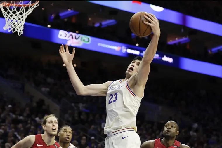 Sixers forward Ersan Ilyasova reaches for the basketball against the Heat during Game 2.