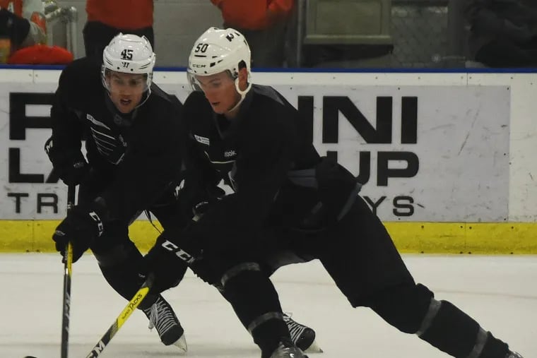 Samuel Morin (front) and Will O’Neill battle for a puck at a practice last year.