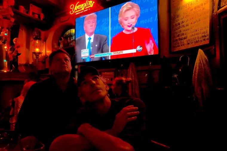 Patrick Keeley, left, and Bil Washlick watch Monday's night's presidential debate at McGillin's Old Ale House on Drury Street. It was one of the area bars hosting watch parties.