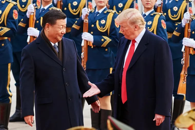 China's President Xi Jinping and U.S. President Donald Trump shake hands on Nov. 9, 2017, during a meeting outside the Great Hall of the People in Beijing.