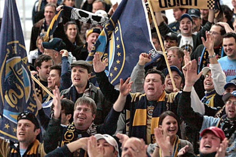 Philadelphia Union fans chant team songs as they march through the
Convention Center. (Elizabeth Robertson/Staff Photographer)