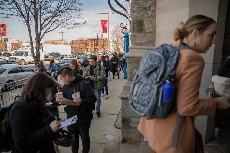 Students at Temple University line up outside of Mitten Hall for a free MMR vaccine following a mumps outbreak at the university on Wednesday. The outbreak has sickened more than 100.