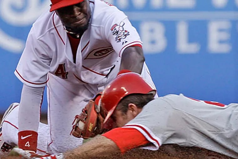 Chase Utley injured his hand on this slide into second base during the fourth inning. (Al Behrman/AP)