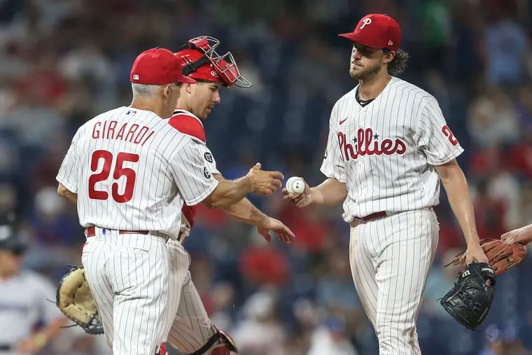 Phillies starter Aaron Nola hands the ball to manager Joe Girardi after giving up a game-tying two-out RBI single to the Marlins' Jesús Sánchez in the fifth inning Wednesday night at Citizens Bank Park.
