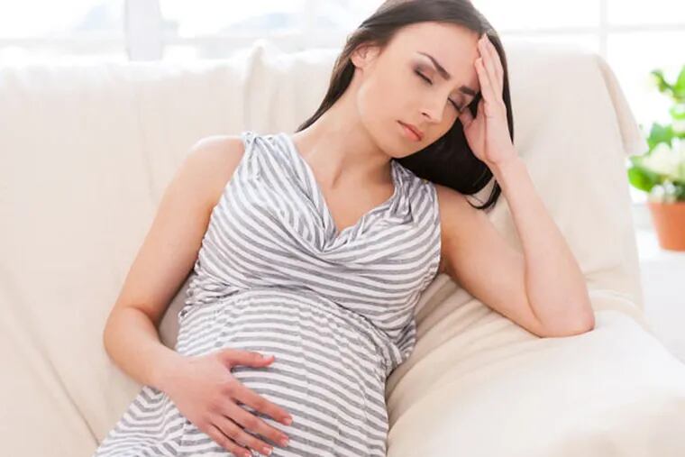 A pregnant woman experiencing discomfort.