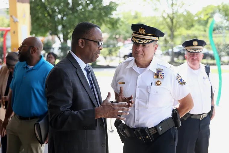 City Council President Darrell Clarke, left, talks with Deputy Police Commissioner Joe Sullivan before a July news conference calling for legislation to ban guns at city recreation centers.