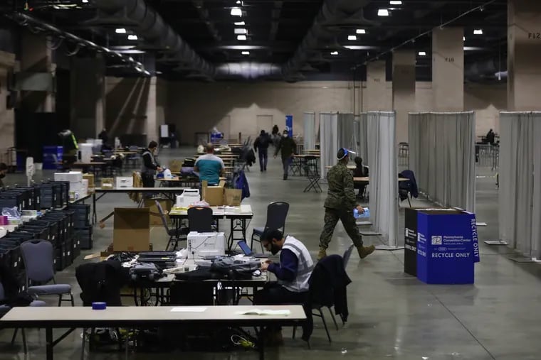 Officials work inside the first day of the FEMA COVID-19 vaccination site at the Pennsylvania Convention Center on March 3.