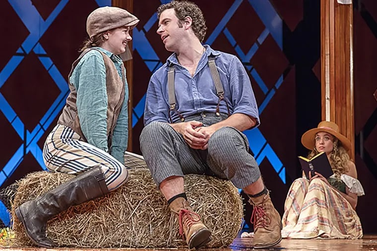 In disguise, Rosalind (Marnie Schulenburg) woos Orlando (Zack Robidas) as Celia (Stella Baker) witnesses their affection, in Pennsylvania Shakespeare Festival’s “As You Like It,” now through Aug. 6, in repertory with Ken Ludwig’s swashbuckling romp ‘The Three Musketeers.’