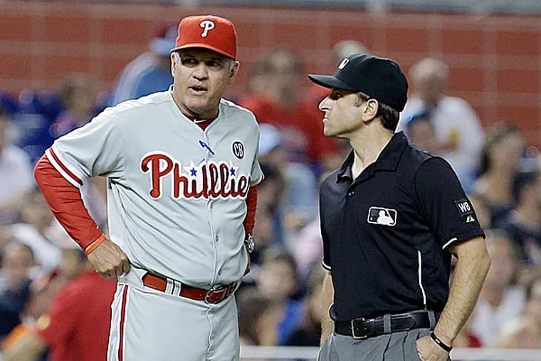 Phillies manager Ryne Sandberg and umpire Chris Guccione. (Wilfredo Lee/AP)