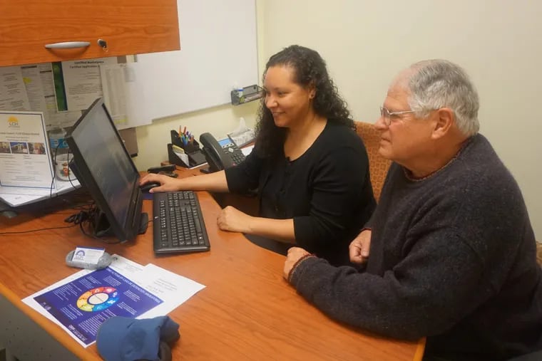 Yessenia Tavarez (left), a caseworker at La Comunidad Hispana in Philadelphia and a certified application counselor under the navigation program of the Affordable Care Act, assists a client with health-care information in a previous enrollment period.