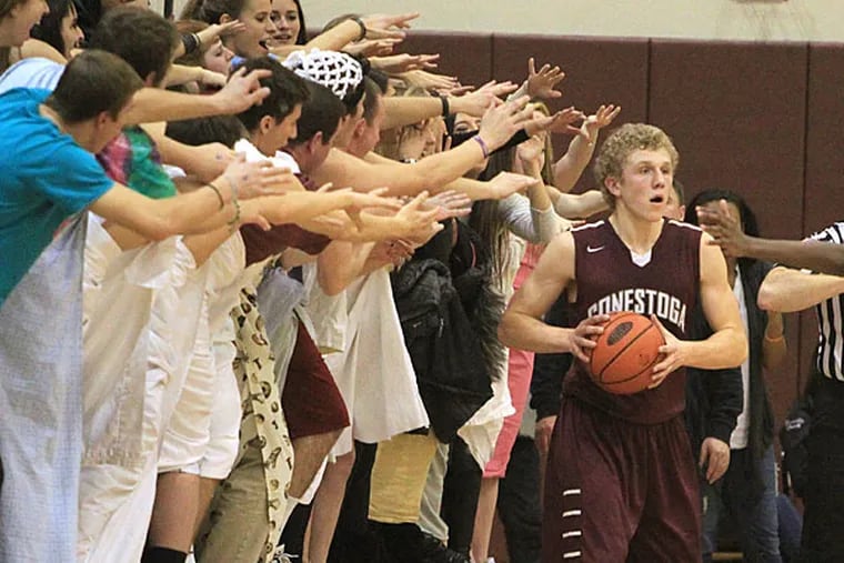 The Lower Merion student section, dressed in togas, does its best to
distract Andrew Diehl of Conestoga as he inbounds the ball in the 4th
quarter in boys' basketball on Dec. 19, 2014.  Conestoga won 51-47 in
a Central League showdown.  (Charles Fox/Staff Photographer)