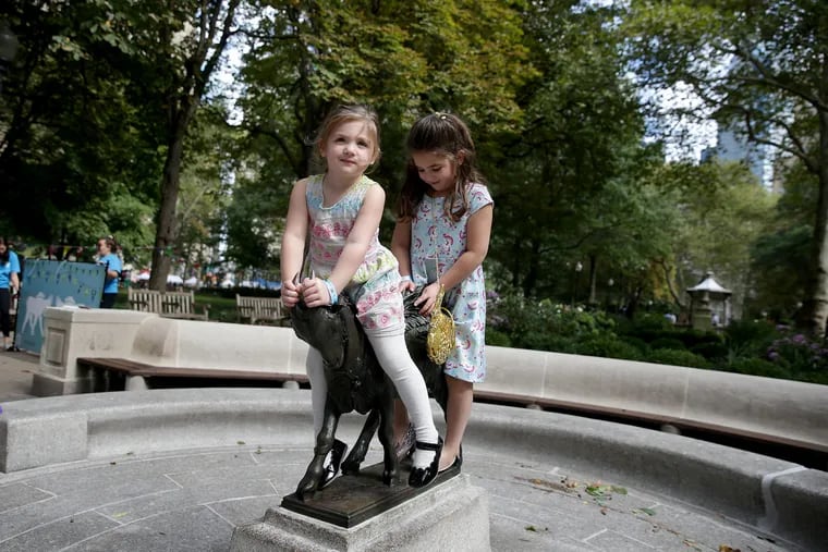 Hattie Morin, 3, (left) and her sister Ruby Morin, 5, sit on the new Billy in Rittenhouse Square.