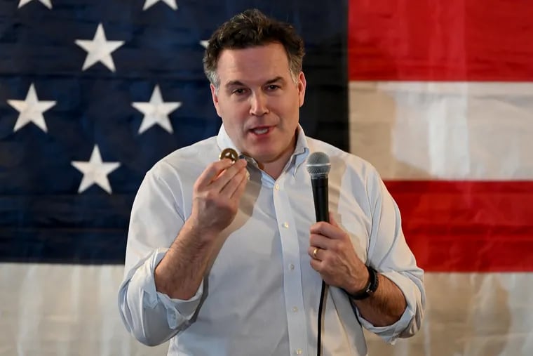 David McCormick, Republican candidate for the U.S. Senate in the Pennsylvania’s primary, holds a gold coin he says was given to him by the mother of a U.S. serviceman who died by suicide after enlisting after 9/11 and serving in Afghanistan. He was speaking at a Luzerne County campaign Meet and Greet, at the American Legion Post 609 in Hanover Township, PA  April 28, 2022.