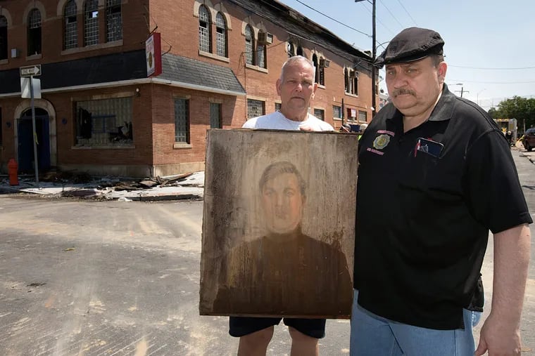 Post commander Pat Driscoll (left) and Pat Love, post adjutant 5th District, with a painting of World War I Pvt. Boleslaw Grochowski in Philadelphia on May 31, 2016.