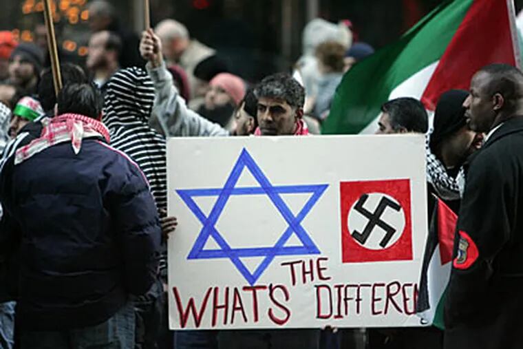 This is the sign - and the photo that ran in the Inquirer - that upset Jewish protesters. (David Swanson / Staff Photographer)