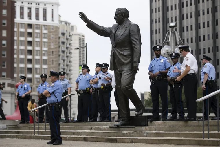 Police officers guard a statue of former Philadelphia mayor and police commissioner Frank Rizzo in Philadelphia, Thursday, Sept. 14, 2017. The statue that has spurred protests and vandalism from critics who argue that his policies alienated minorities.