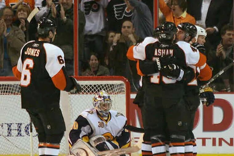 Flyers celebrate after Glen Metropolit&#0039;s first-period goal got past Buffalo goalie Ryan Miller.