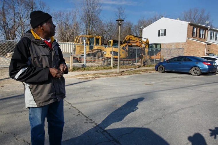 Earl Wilson, of the Eastwick Association, talks about the area behind him that the EPA is cleaning up, near the backyards of residents, in Eastwick.