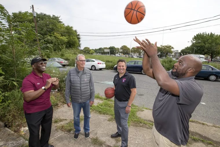 Philadelphia Youth Basketball foundation hopes basketballs will one day soar over a neighborhood that once sunk. They hope to build a basketball facility on the Logan Triangle, once home to sinking homes that had to be demoslihed. L-R: Board member and former coach Bill Ellerbee, board member John Langel, CEO and Executive DIrector Kenny Holdsman, co-founder/Program Director Eric Worley. CHARLES FOX / Staff Photographer