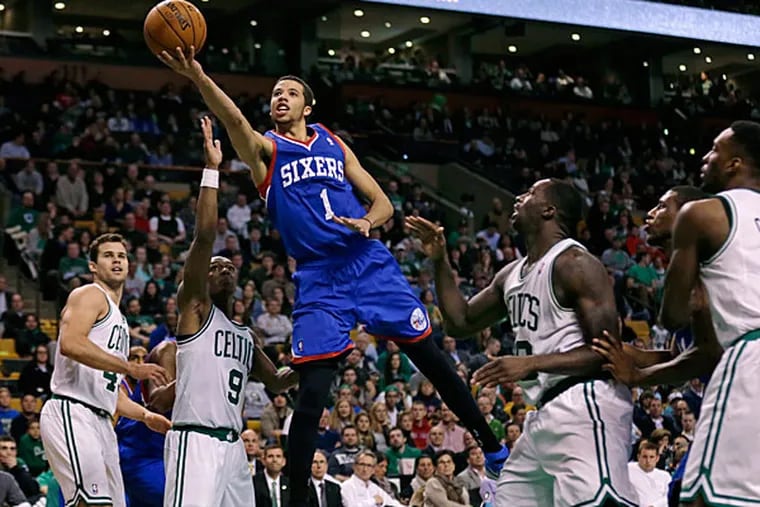 Michael Carter-Williams (1) drives through the Boston Celtics for a basket during the second half of an NBA basketball game Friday, April 4, 2014, in Boston. Carter-Williams had 24 points in the 76ers' 111-102 win. (Charles Krupa/AP)