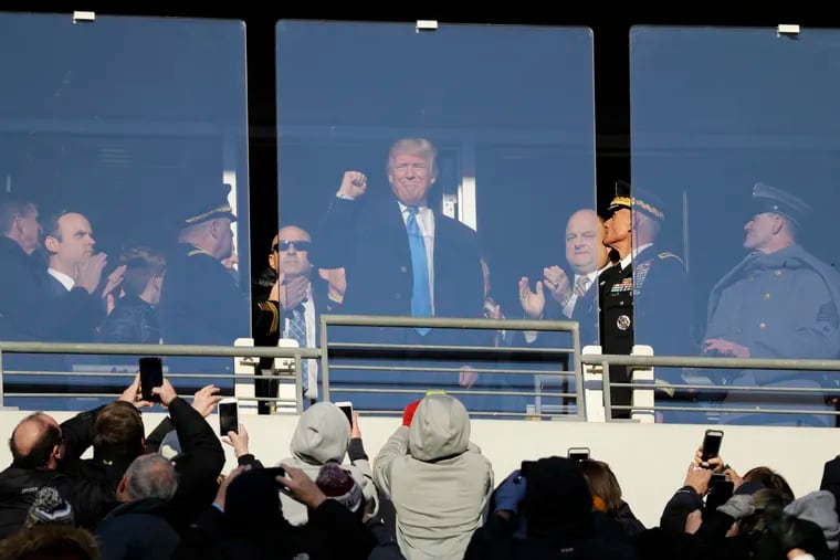 In this file photo from Dec. 10, 2016, file photo, then President-elect Donald Trump acknowledges spectators during the first half of the Army-Navy football game in Baltimore.