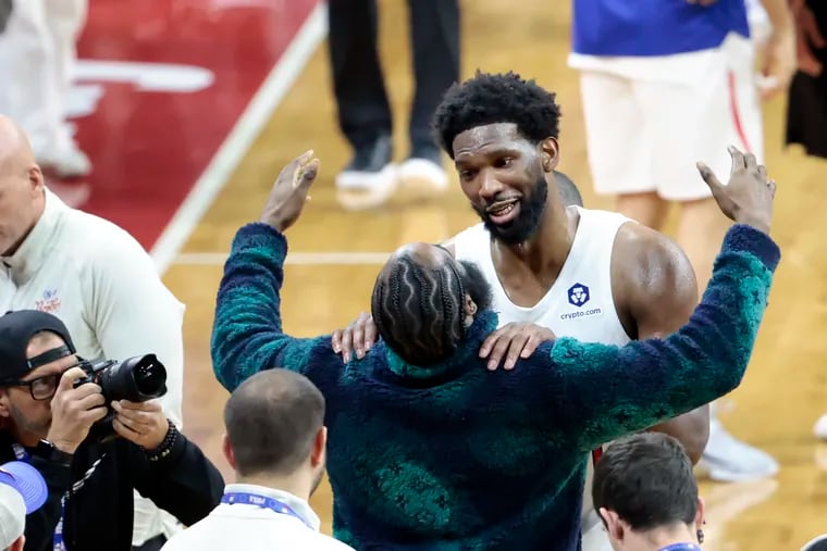 Joel Embiid is embraced by James Harden after Embiid scored 59 points in a win over the Utah Jazz on Sunday.