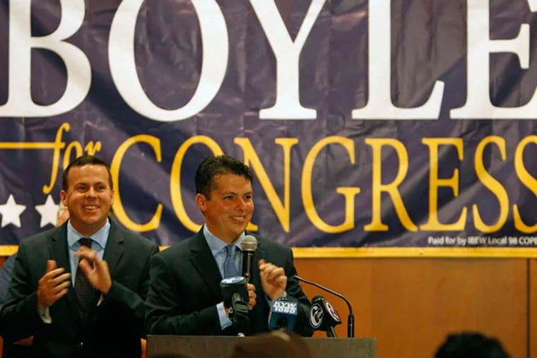 Brendan Boyle celebrates at the lectern , flanked by his brother Kevin, at the Heroes Ballroom of Fraternal Order of Police Lodge No. 5. RON CORTES / Staff Photographer