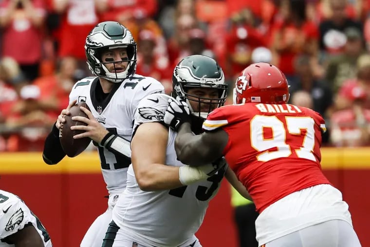 Eagles quarterback Carson Wentz is protected by  guard Isaac Seumalo, who had a rough game against the Chiefs.